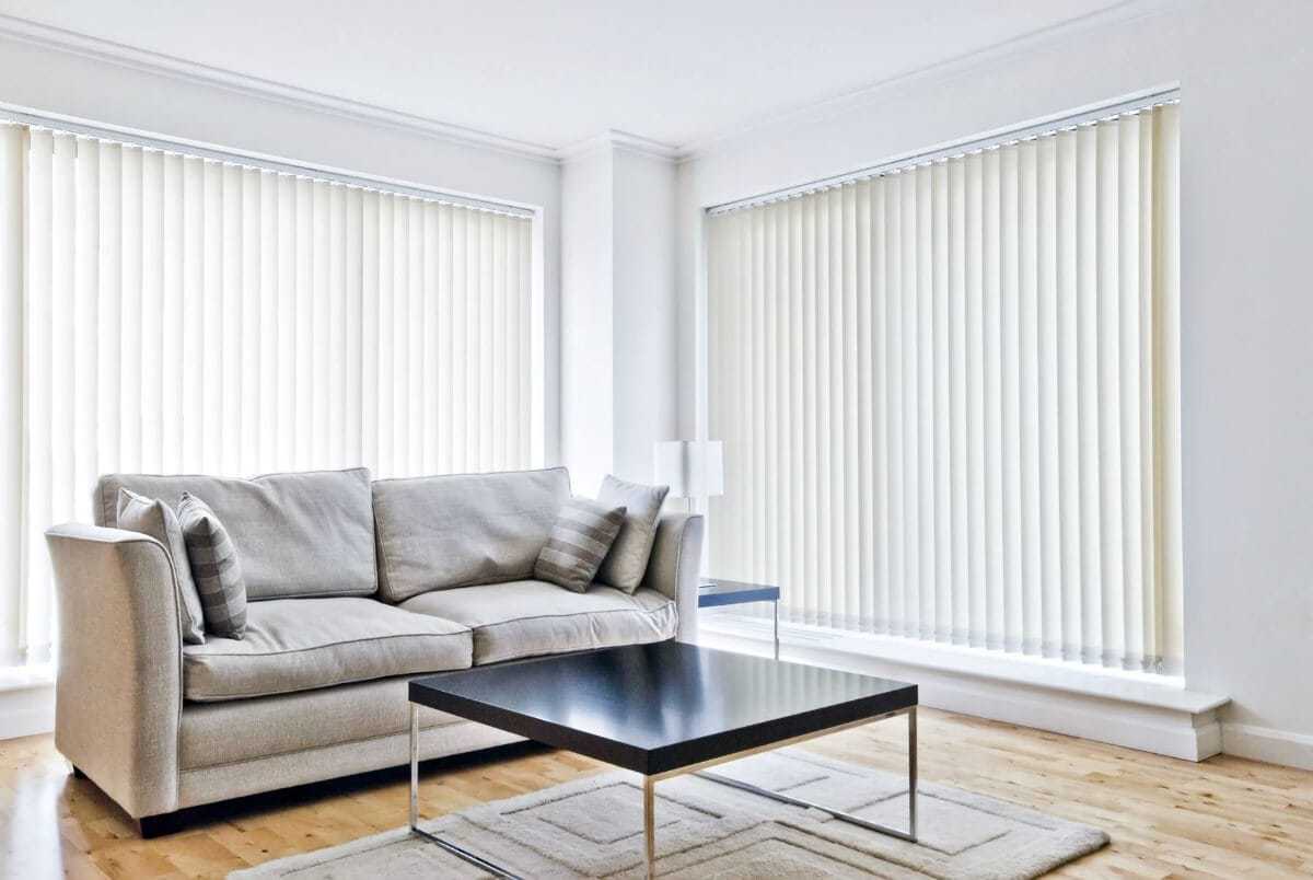 white-vertical-blinds-in-living-room-with-grey-sofa-and-chocolate-brown-coffee-table